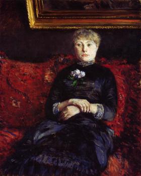 Woman Sitting on a Red Flowered Sofa